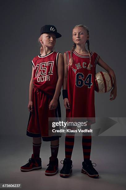 portrait of cool young twin ball players - twin girls stock pictures, royalty-free photos & images