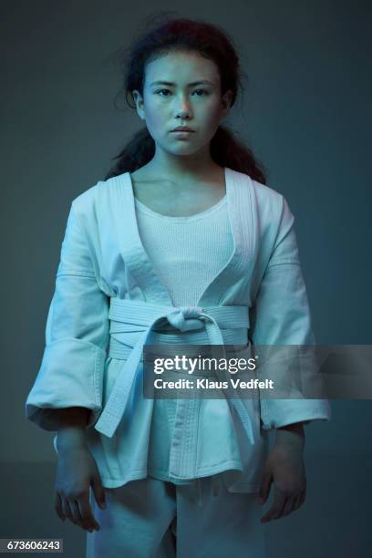 portrait of young female martial arts athlete - martial arts kid stock pictures, royalty-free photos & images