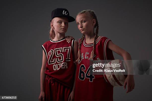 portrait of cool young twin ball players - twin girls stock pictures, royalty-free photos & images