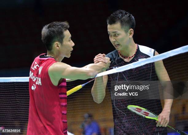 Lee Chong Wei of Malaysia and Kenta Nishimoto of Japan shake hands during 2017 Badminton Asia Championships men's singles second round match at Wuhan...