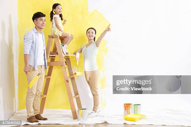 happy families in the paint for the walls - 4 girls finger painting bildbanksfoton och bilder