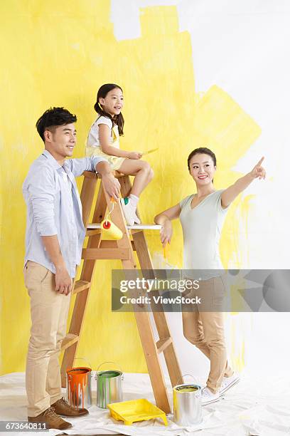 happy families in the paint for the walls - 4 girls finger painting bildbanksfoton och bilder
