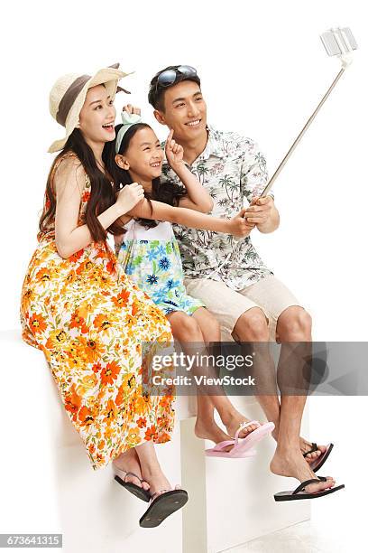 the happiness of a family of three with mobile phone self timer - taking selfie white background stock pictures, royalty-free photos & images