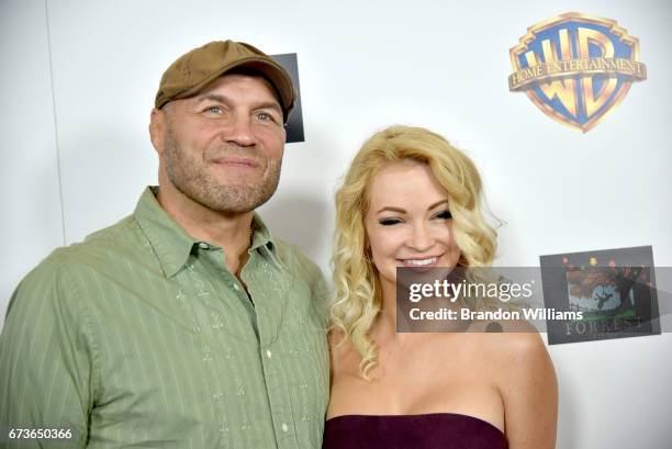 Actor / retired mixed martial artist Randy Couture and actor / model Mindy Robinson attend the premiere of 'American Wrestler: The Wizard' at Regal...