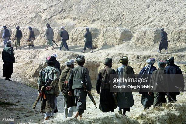 Northern Alliance fighters battle pro-Taliban forces November 27, 2001 in a fortress near Mazar-e-Sharif, Afghanistan. The Northern Alliance, helped...