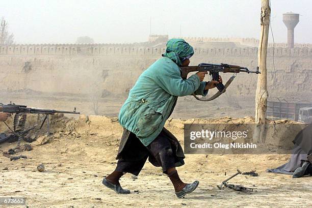 Northern Alliance fighters battle pro-Taliban forces November 27, 2001 in a fortress near Mazar-e-Sharif, Afghanistan. The Northern Alliance, helped...