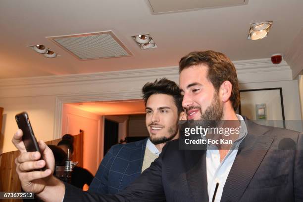 Model Baptiste Giabiconi and a guest pose for a selfie during "Aston Martin by Hackett" : Capsule Collection Launch at Hackett Store Capucines on...