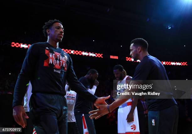 DeMar DeRozan of the Toronto Raptors high fives teammate Norman Powell during player introductions prior to the first half of Game Five of the...