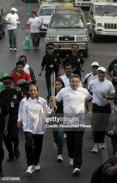 Bollywood actor Vinod Khanna carrying the Marathon flame as it arrives, on January 10, 2010 in Mumbai, India. Veteran actor and sitting BJP MP Vinod...