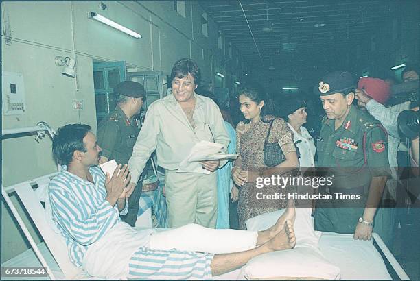 Bollywood actor Vinod Khanna along with injured soldiers at Army Hospital, on July 7, 1999 in New Delhi, India. Veteran actor and sitting BJP MP...