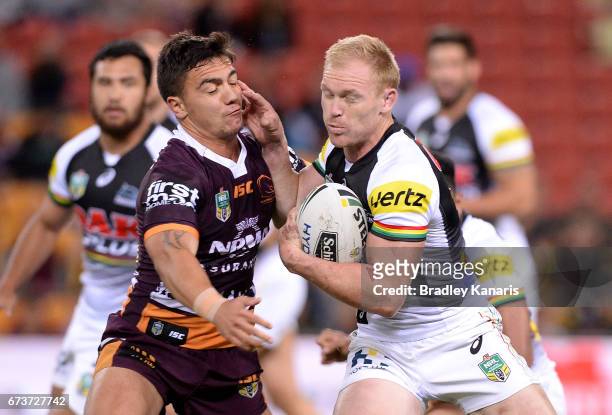 Peter Wallace of the Panthers takes on the defence of Kodi Nikorima of the Broncos during the round nine NRL match between the Brisbane Broncos and...