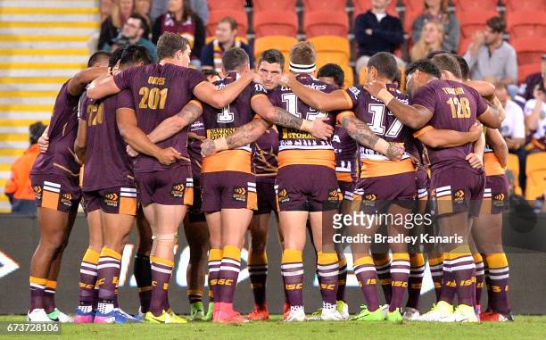 Broncos players embrace before the round nine NRL match between the Brisbane Broncos and the Penrith Panthers at Suncorp Stadium on April 27, 2017 in...