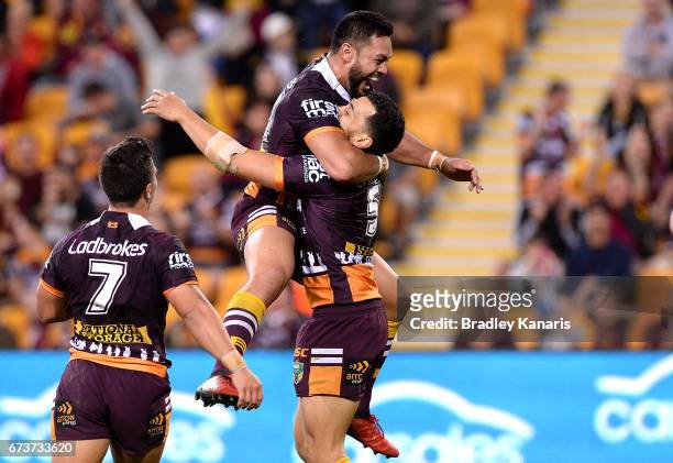 Jordan Kahu of the Broncos is congratulated by team mates after scoring a try during the round nine NRL match between the Brisbane Broncos and the...