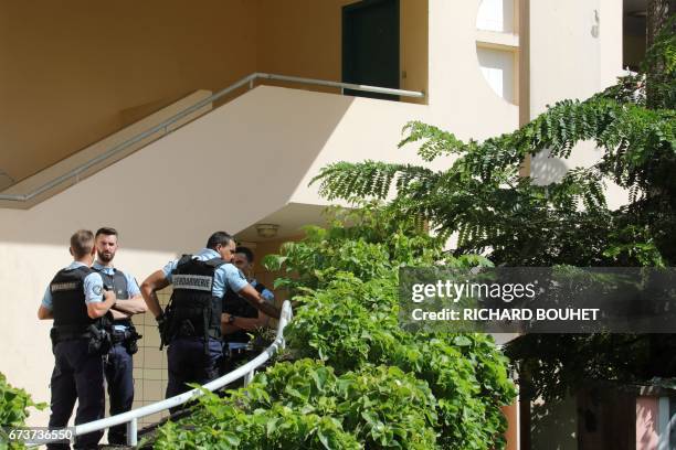French gendarmes stand at the entrance of a building on April 27, 2017 in Saint-Denis-de-la-Reunion, on the French Indian Ocean island of Reunion,...
