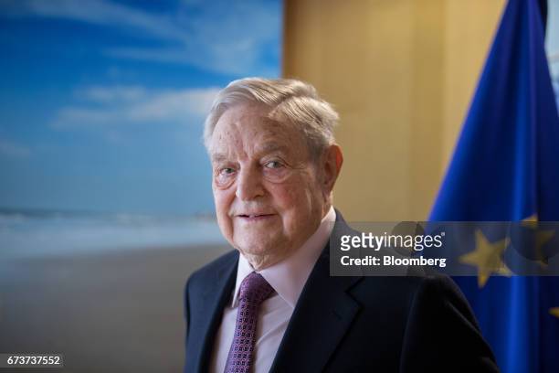 George Soros, billionaire and founder of Soros Fund Management LLC, poses for a photograph ahead of a meeting with the President of the European...