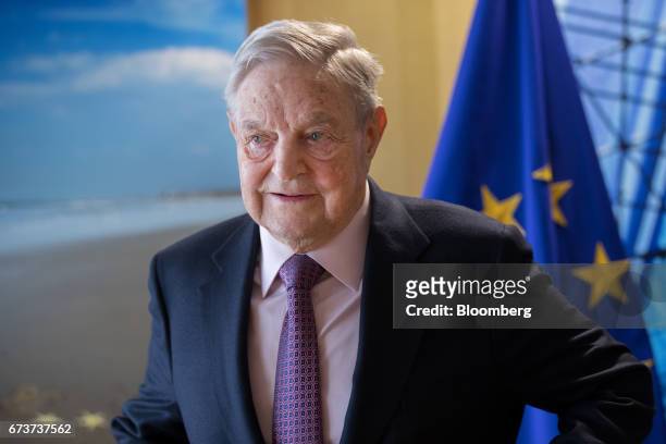 George Soros, billionaire and founder of Soros Fund Management LLC, poses for a photograph ahead of a meeting with the President of the European...