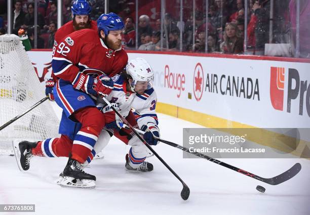 Steve Ott of the Montreal Canadiens checks Mats Zuccarello of the New York Rangers in Game Five of the Eastern Conference Quarterfinals during the...