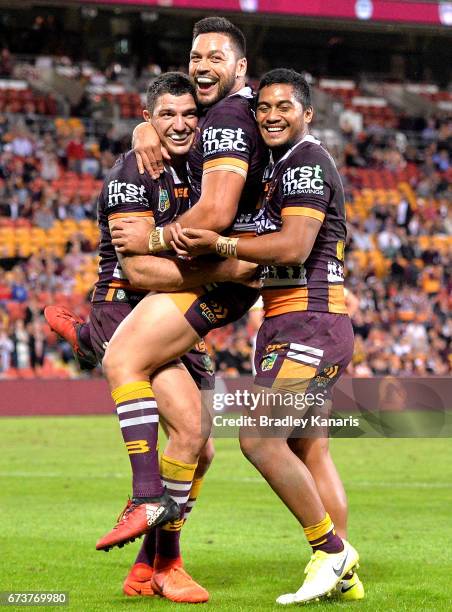 Matt Gillett of the Broncos is congratulated by team mates after scoring a try during the round nine NRL match between the Brisbane Broncos and the...