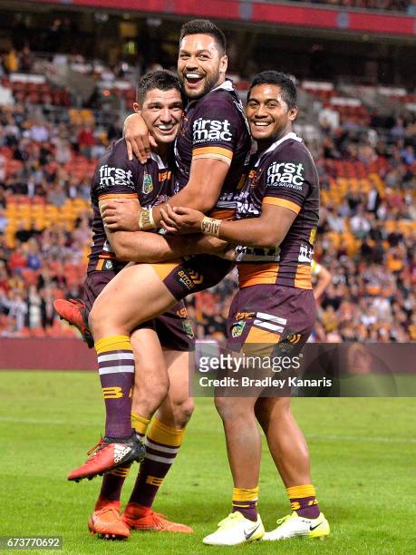 Matt Gillett of the Broncos is congratulated by team mates after scoring a try during the round nine NRL match between the Brisbane Broncos and the...