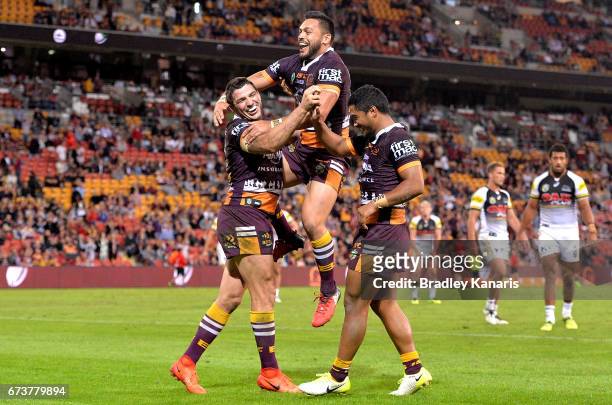 Matt Gillett of the Broncos is congratulated by team mates after scoring a try during the round nine NRL match between the Brisbane Broncos and the...