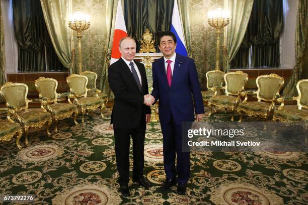 Russian President Vladimir Putin meets Japanese Prime Minister Shinzo Abe during talks at the Grand Kremlin Palace on April 2017 in Moscow, Russia....