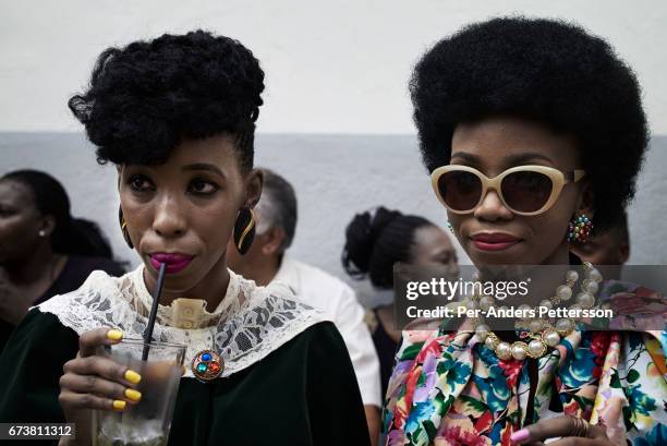 U2013 MARCH 7: Botswana fashion bloggers Gaone Mothibi and Tsholo Dikobe wait for a show with the South African designer David Tlale during the...