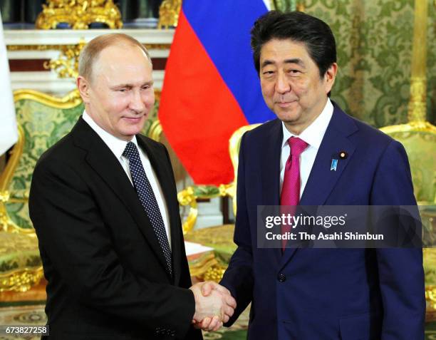 Japanese Prime Minister Shinzo Abe and Russian President Vladimir Putin shake hands prior to their meeting at Kremlin on April 27, 2017 in Moscow,...