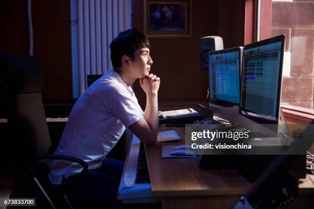 man working at mixing panel in a recording studio - sound producer stock pictures, royalty-free photos & images