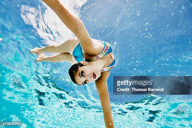 synchronized swimmer diving underwater - synchronised swimming stock pictures, royalty-free photos & images