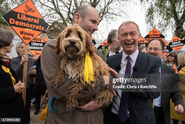 Liberal Democrats party leader Tim Farron walks over to pet cockapoo dog 'Bonnie' as he is campaigning for the British general election at Eastfield...