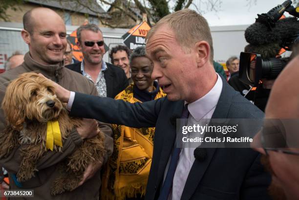 Liberal Democrats leader Tim Farron pets cockapoo dog 'Bonnie' whilst campaigning for the British general election at Eastfield regeneration site on...