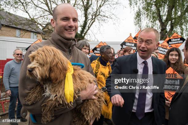 Liberal Democrats party leader Tim Farron walks over to pet cockapoo dog 'Bonnie' as he is campaigning for the British general election at Eastfield...