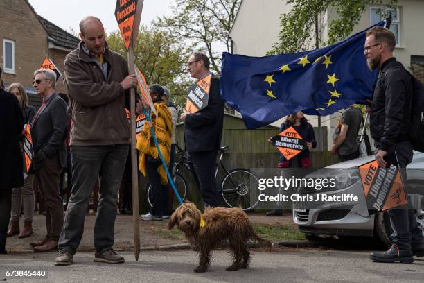 Cockapoo dog 'Bonnie' is seen next to a European Union flag and Liberal Democrats supporters as party leader Tim Farron campaigns for the British...