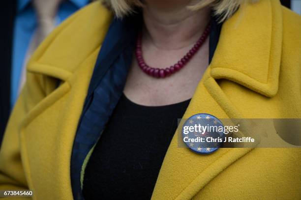 Badge is seen on the coat of a Liberal Democrats supporter as party leader Tim Farron campaigns for the British general election at Eastfield...