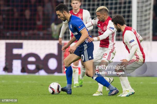 Nabil Bentaleb of Schalke and Hakim Ziyech of Ajax Amsterdam battle for the ball during the UEFA Europa League Quarter Final first leg match between...