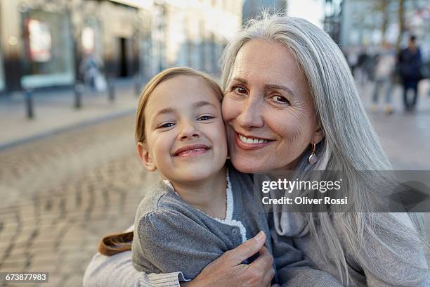 portrait of smiling grandmother with granddaughter - granddaughter 個照片及圖片檔