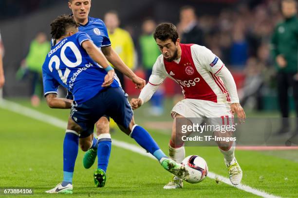 Thilo Kahrer of Schalke and Amin Younes of Ajax Amsterdam battle for the ball during the UEFA Europa League Quarter Final first leg match between...