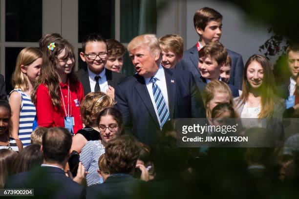 President Donald Trump poses with children during a 2017 "Take Your Daughters and Sons to Work Day" event at White House in Washington, DC, April 27,...