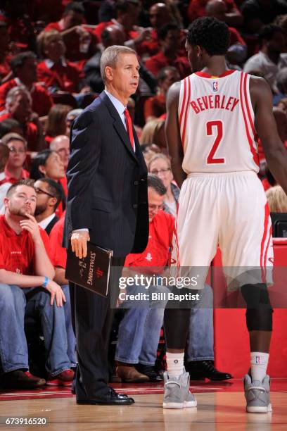 Jeff Bzdelik and Patrick Beverley of the Houston Rockets talk during Game Five of the Western Conference Quarterfinals against the Oklahoma City...