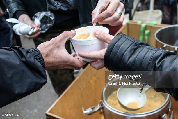 Homeless people receive a hot meal during 'Soup on Planty' event at Planty park in Krakow, Poland on 27 April, 2017. &quot;Soup on Planty&quot; is a...