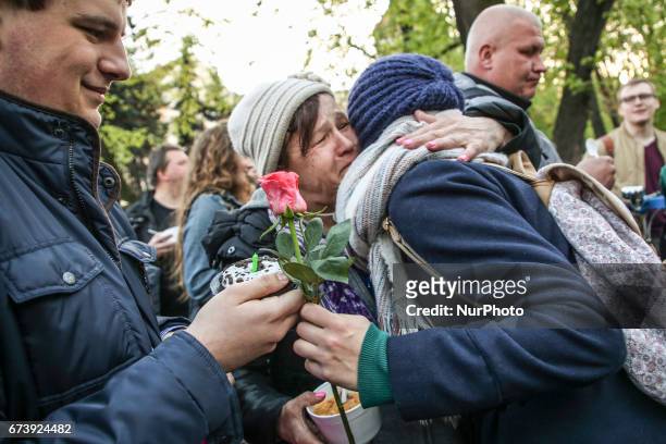 Homeless woman wishes happy birthday to a volunteer during 'Soup on Planty' event at Planty park in Krakow, Poland on 27 April, 2017. 'Soup on...