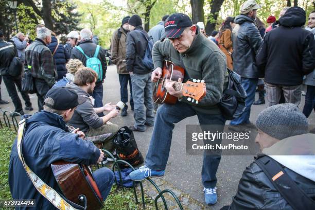 Homeless man plays guitar during &quot;Soup on Planty&quot; event at Planty park in Krakow, Poland on 27 April, 2017. &quot;Soup on Planty&quot; is a...