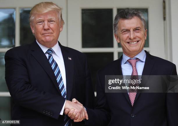 President Donald Trump shakes hands with President Mauricio Macri of Argentina shortly before meeting in the Oval Office of the White House on April...