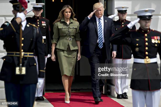 President Donald Trump, right, salutes as he walks out of the South Portico of the White House with U.S. First Lady Melania Trump to greet Mauricio...