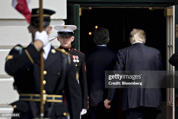 President Donald Trump, right, and Mauricio Macri, Argentina's president walk into the Whiter House at the South Portico in Washington, D.C., U.S.,...