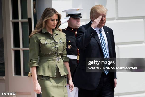 First Lady Melania Trump and US President Donald Trump arrive to greet Argentina's President Mauricio Macri outside the White House April 27, 2017 in...