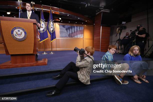 Sever-year-old Archer Somodevilla photographs Speaker of the House Paul Ryan during Ryan's weekly news conference at the U.S. Capitol Visitors Center...