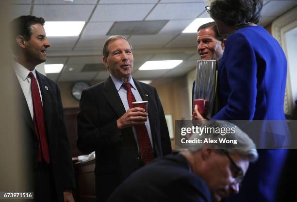 Sen. Tom Udall chats with Rep. John Sarbanes , Sen. Richard Blumenthal and Rep. Katherine Clark prior to a news conference at the Capitol April 27,...