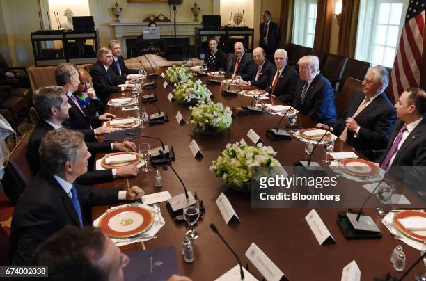 President Donald Trump, center right, listens while Mauricio Macri, Argentina's president, center left, speaks during a luncheon at the White House...
