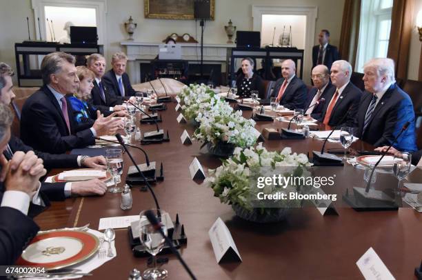 Mauricio Macri, Argentina's president, left, speaks while U.S. President Donald Trump, right, listens during a luncheon at the White House in...